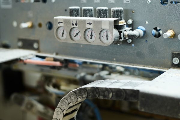 Close-up of indicators showing the pressure on machine equipment at factory